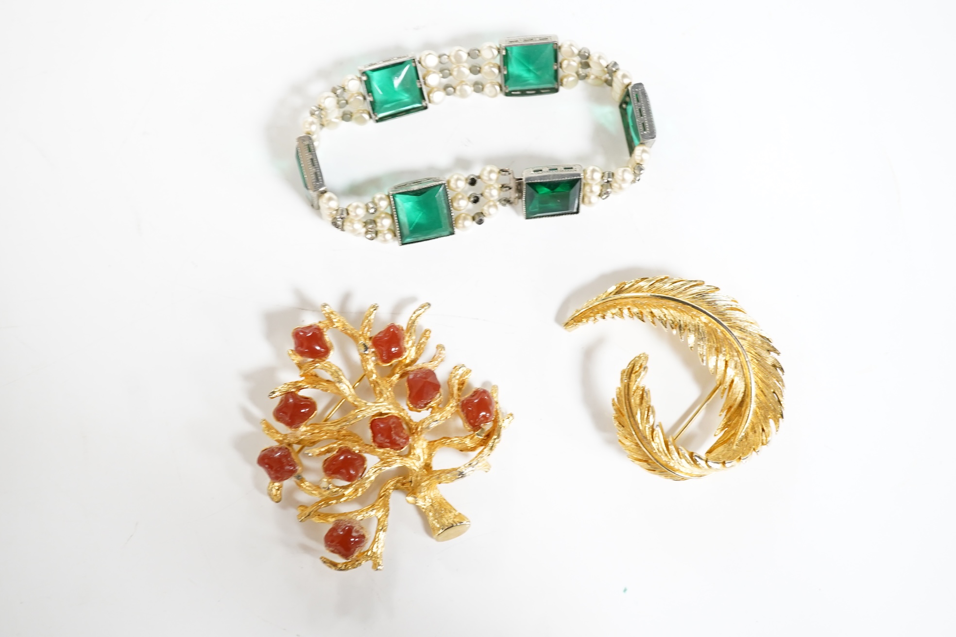 A lady's Retro gold watch by DelBana, 1940s, the square dial in a rose gold case accented with rubies, stamped 14K, to a black cord strap; together with a collection of assorted costume jewels, in a two-tiered white leat